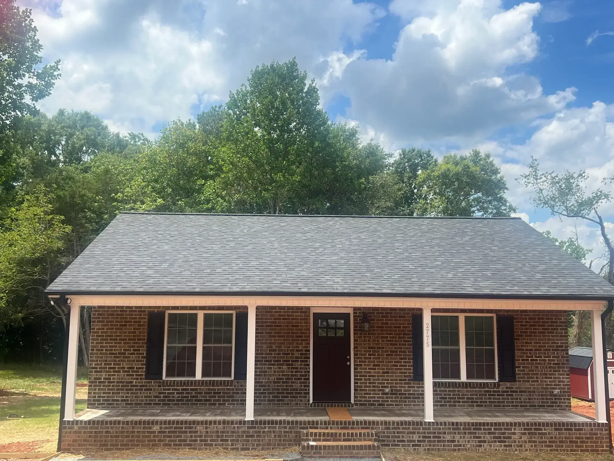 Ranch-style brick house with navy shutters