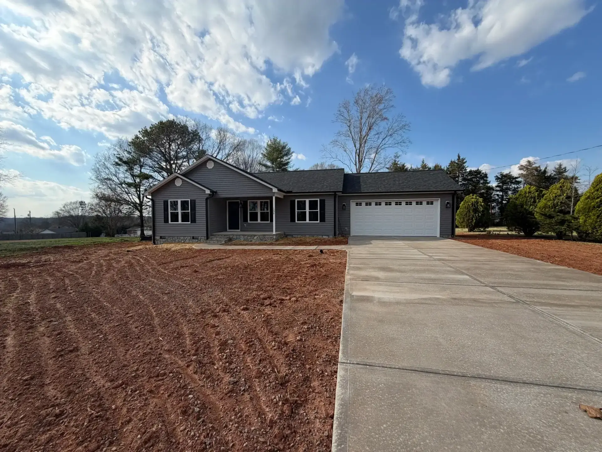 Single-story gray house with driveway and garage