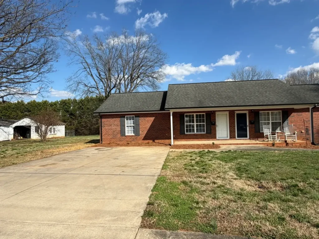 Front porch with two doors and rocking chairs